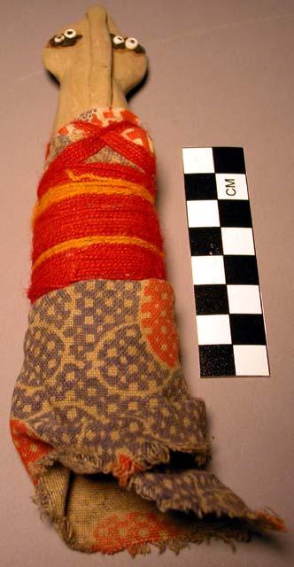 Child's doll - clay wrapped with cloth and red and yellow woolen +