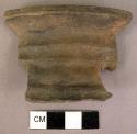 Black ware rim sherd - thick wide lip, horizontal bands formed by finger pressur