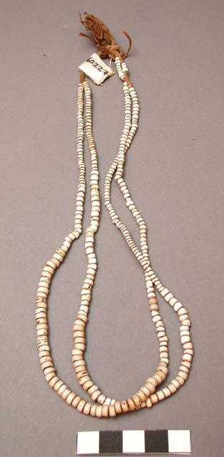 Crow necklace. Consists of 2 strands of old white beads of varying size.