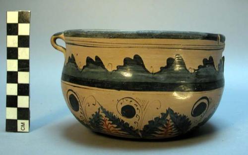 Pottery bowl -- buff with red and blue curvilinear design