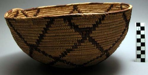 Fancy grain basket made of single coils of vine and closely joined by palmetto.