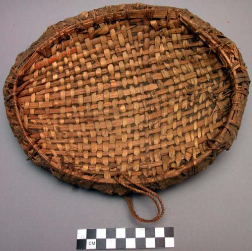 Woven straw dish with cow dung plastered on back - 10" long ("bukoko")