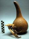 Gourd vessel with opening on side and grass stopper. Luwoko
