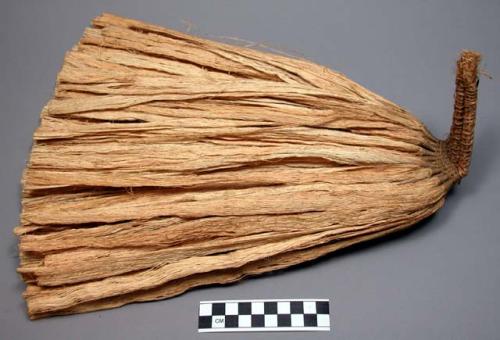 Woman's tail of strips of chewed fibre