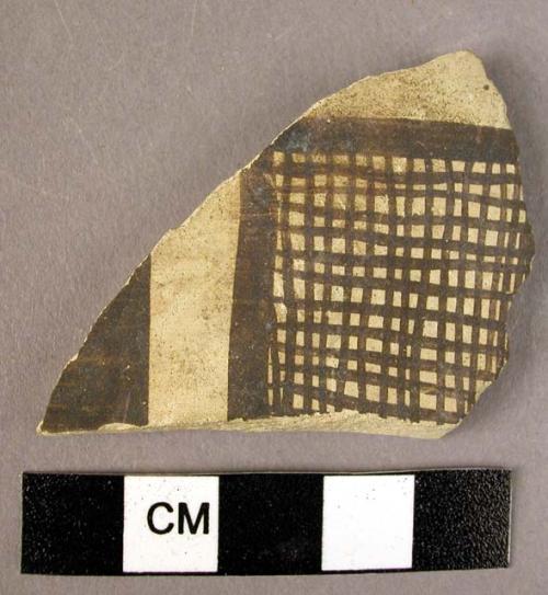 Ceramic body sherd, buff ware w. black painted geometric design.