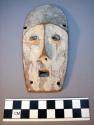 Wooden mask with patine of white kaolin; square chin; high forehead (5 1/2" high