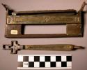 Key (b) The key is in the shape of an elongated cross, with incised designs on o