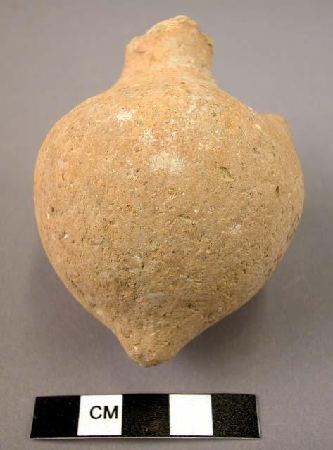 Small coarse brown pottery jar- pointed base with fragment of handle or lug