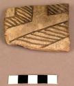 Ceramic rim sherd, black on white checked interior, mended