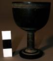 Small wooden cup on stand