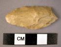 Flint bifacially worked point on flake, ireegular shape; base concave