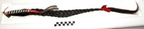 Sioux hair ornament made from braided horsehair. Decorated w/ beaded hide and qu
