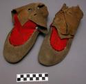 One pair of skin moccasins with red cloth decoration