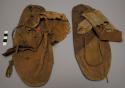 Pair of Plains moccasins, possibly Omaha. Soles of parfleche. Soft uppers
