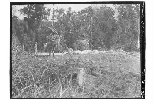 Men digging post holes for house