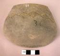 Black pottery rim sherd with incised designs