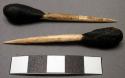 Two sticks with domed ends, bone, vegetable resin