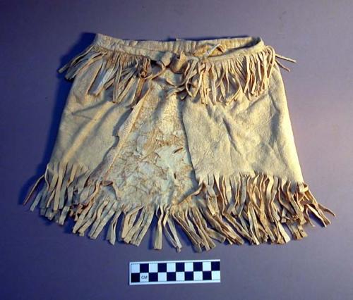 Girl's buckskin apron. Bottom fringe.