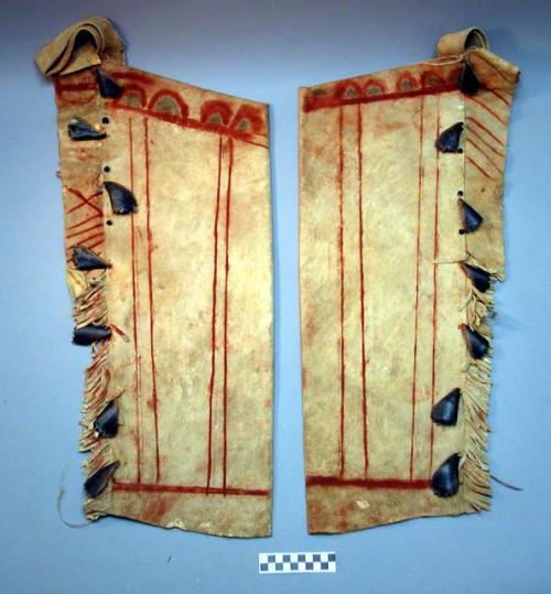 Man's buckskin leggings, fringed. Lower part of fringes cut; upper part uncut.