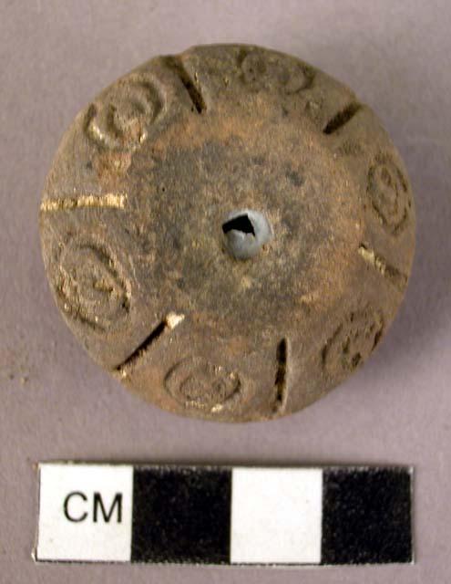 Pottery spindle whorl with incised and colored designs