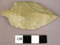 Leaf shaped projectile, with stem; slightly convex, one surface.  Fine grained w