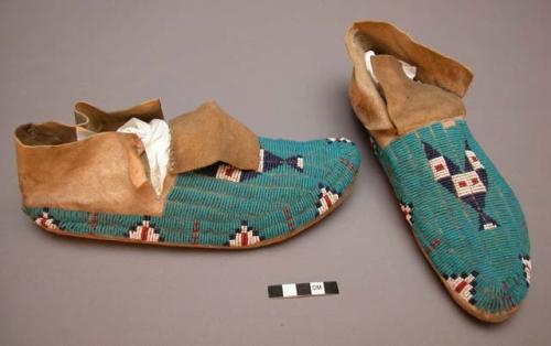 Pair of beaded Sioux moccasins. Hard soles. Soft uppers stitched up heel