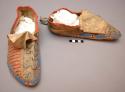 Pair of Sioux moccasins. Soles made from parfleche. Soft uppers, sewn up heel.