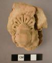 Clay fragment; relief of vase; unbaked.