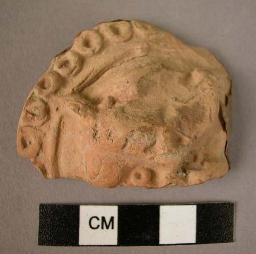 Pot sherd; grotesque face in relief.