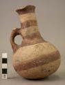 Single-handled, long, thin neck pottery jug