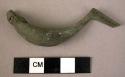 Metal personal ornament, bronze fibula, boat type, incised, pin missing, corroded