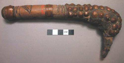 Copper studded handle of hammer - used to kill the chicken by breaking its throa