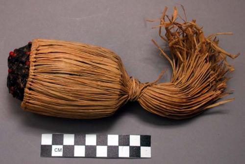 Raffia covered pottery whistle, used to create voice of the "Ge"