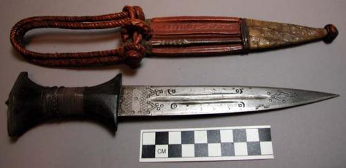 Steel knife with wooden handle; silver wire decoration; in a leather sheath whic