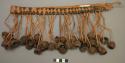 Plaited straw belt with nut pendants all around - ceremonial