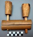 Unclassified tool, carved wood cylinder, halved, perforated; flared toggles