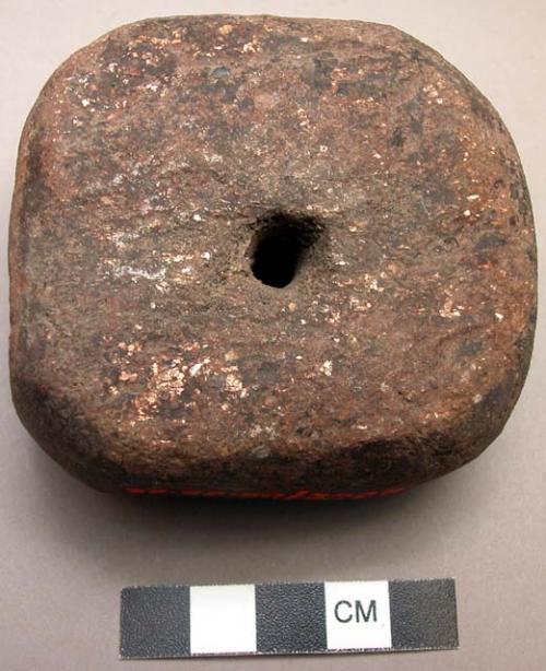 Round stone charm with hole in center for piece of iron which has been lost (cf.