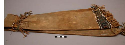 Gun case attributed to the Sioux. Fringe at each end and around center. White an