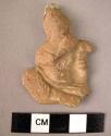 Relief figurine; female musician; complete.