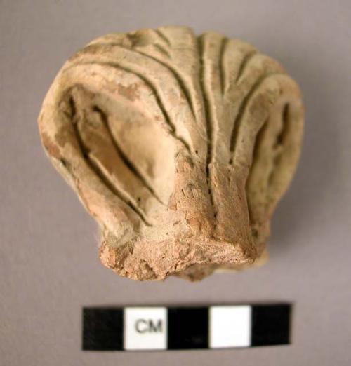 Pottery fragment; raised loops, incised lines.