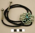 Bolo, round openwork flower with a small turquoise stone set in the center