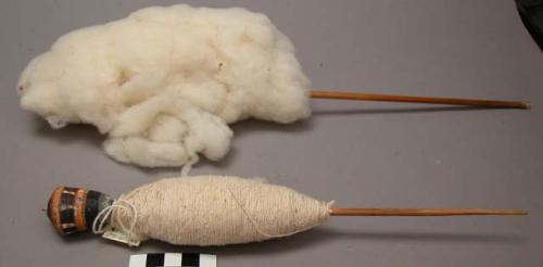 Spindle with raw cotton distaff