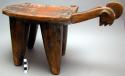 Carved wooden stool with shield-like seat