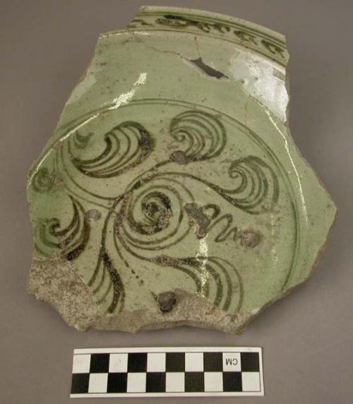 Ceramic partial bowl, green w. dark green floral design, glazed, ring base