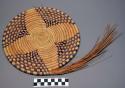 Medium sized basketry plate, coiled weave in process of being made; checkered tr