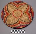 Medium-sized basketry plate, coiled basketry, four-leaf pattern in purple, vermi