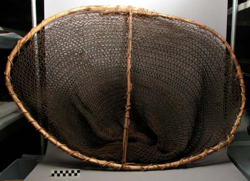 Woman's fishing net of string with reed frame