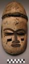 Ekpo mask, wood with brown paint and rectangular holes under eyes. White paint