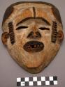 Wooden mask, 8.25" high, white decoration on brown