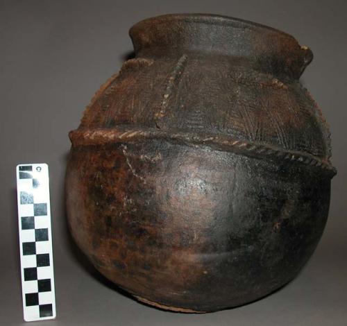 Black pottery vessel with incised decoration, probably for storage